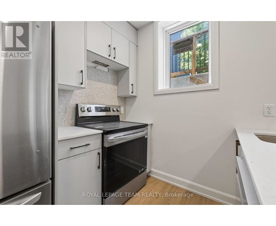 A small kitchen with a stove top oven and a refrigerator.