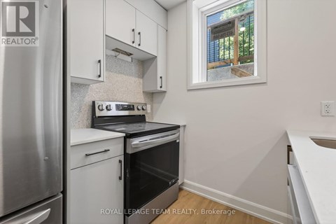 A small kitchen with a stove top oven and a refrigerator.