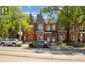 A street view of a residential area with a house and parked cars.