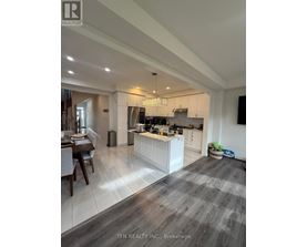 A modern kitchen with a dining table and a large island.