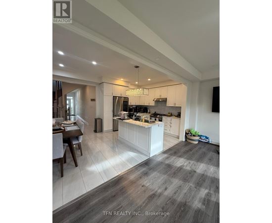 A modern kitchen with a dining table and a large island.