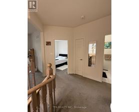 A bedroom with a bed, dresser, and mirror.