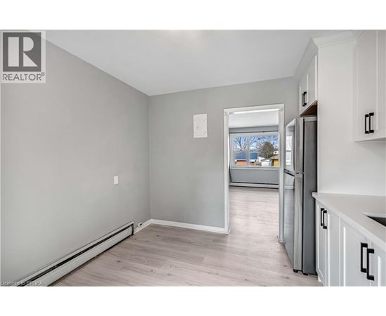A realtor's image of a kitchen and living room.