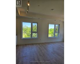 A room with two windows and a ceiling fan.