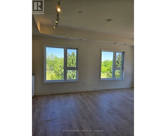 A room with two windows and a ceiling fan.