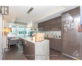 A modern kitchen with a large island and stainless steel appliances.