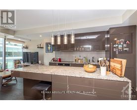 A modern kitchen with a large island and stainless steel appliances.