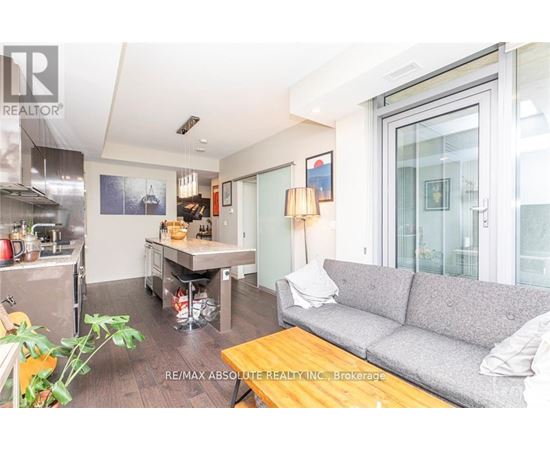 A living room with a grey couch and a wooden coffee table.