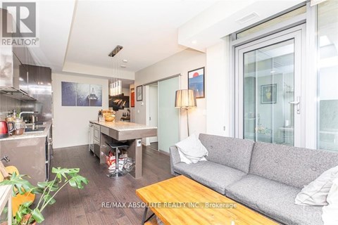 A living room with a grey couch and a wooden coffee table.
