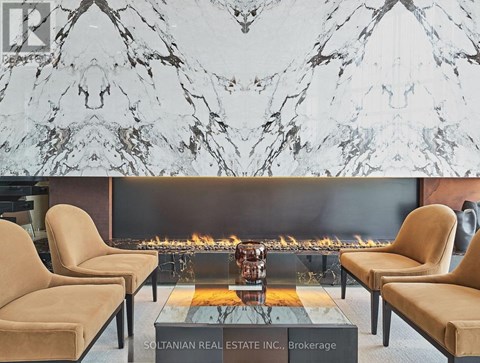 A living room with a fireplace and chairs.