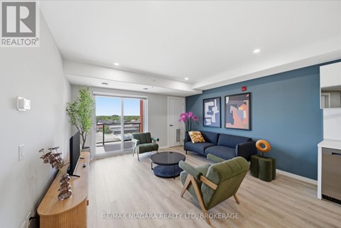 A living room with a green chair and a blue couch.