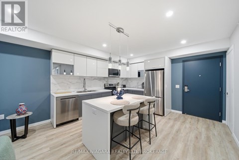 A modern kitchen with a dining table and chairs.