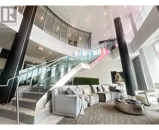 A living room with a staircase and a couch.