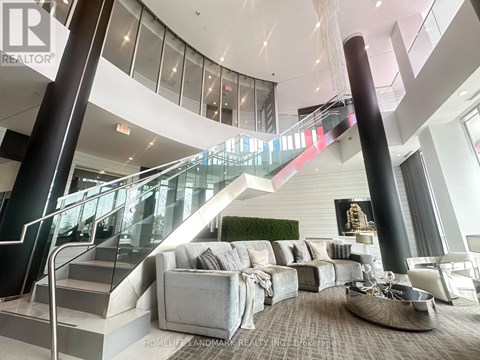 A living room with a staircase and a couch.