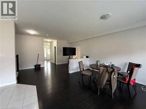 A living room with a dining table and chairs.