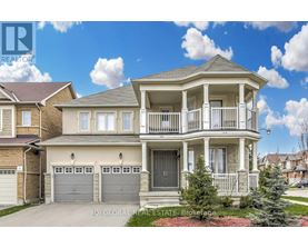 A two-story house with a balcony and a garage.