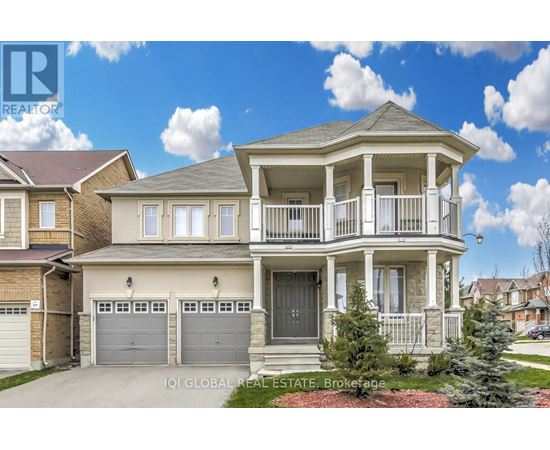 A two-story house with a balcony and a garage.