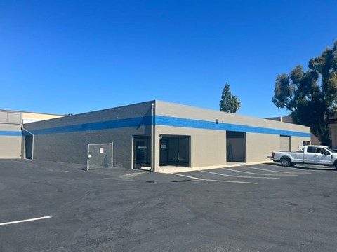A large industrial building with a white truck parked in front.