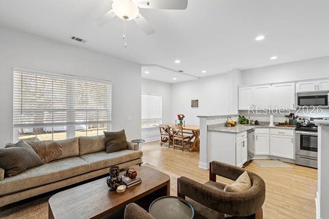 A modern living room with a brown couch and a wooden coffee table.
