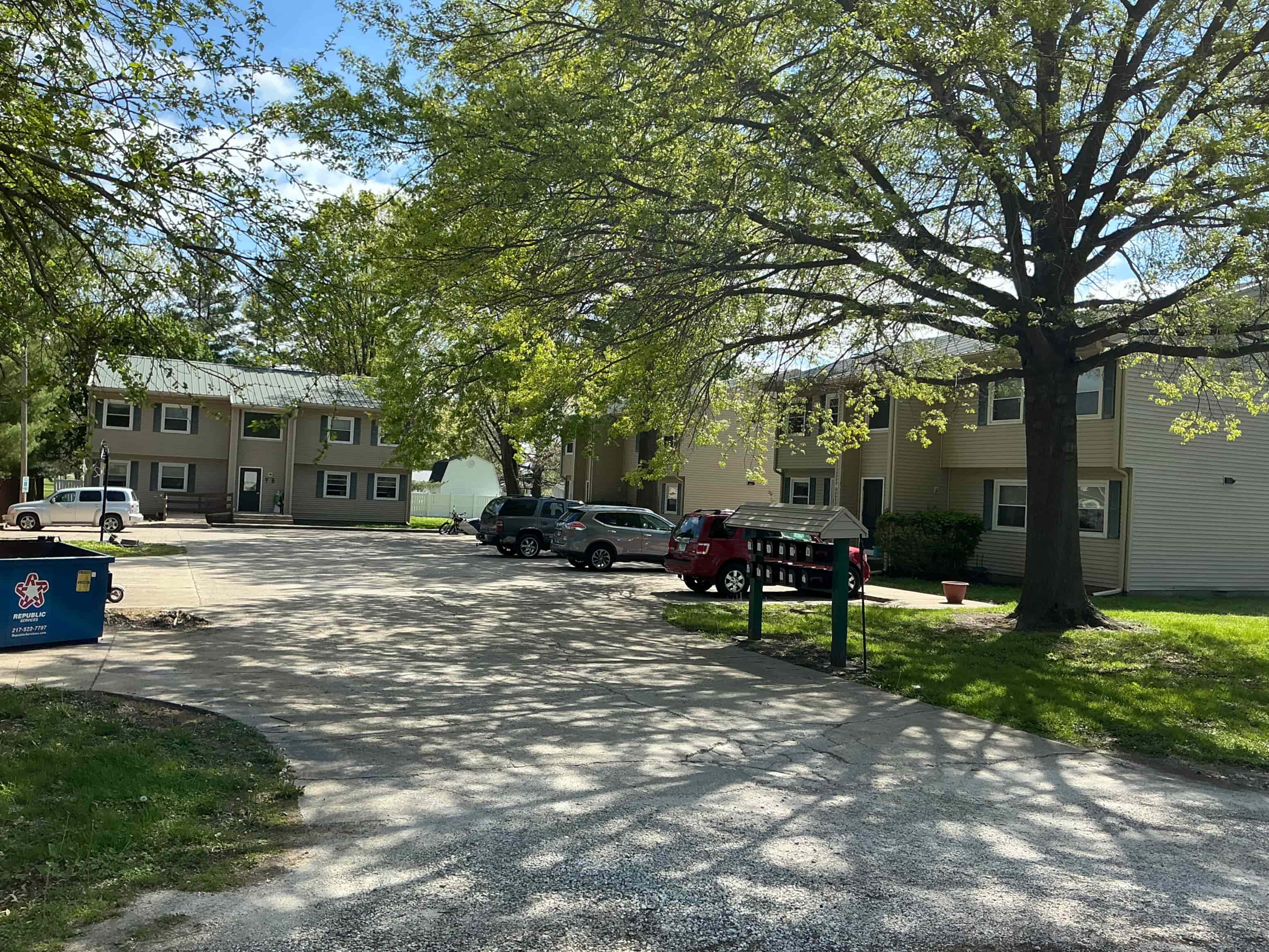 A residential area with houses and parked cars.