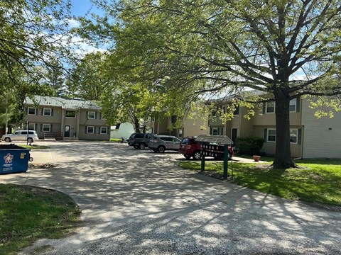 A residential area with houses and parked cars.