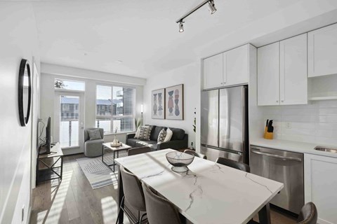 A modern kitchen with a dining table and chairs.