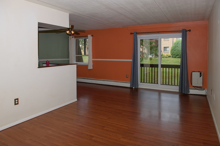 A room with a sliding glass door leading to a balcony.