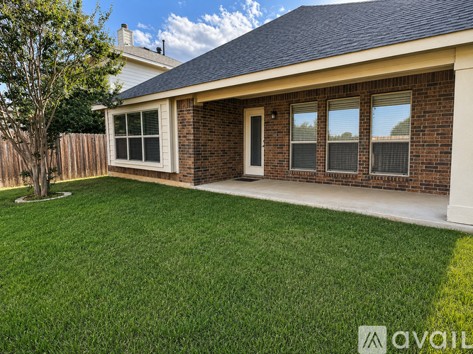 A house with a brick exterior and a white window is for sale.