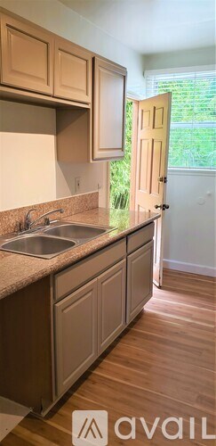 A kitchen with wooden cabinets and a sink.