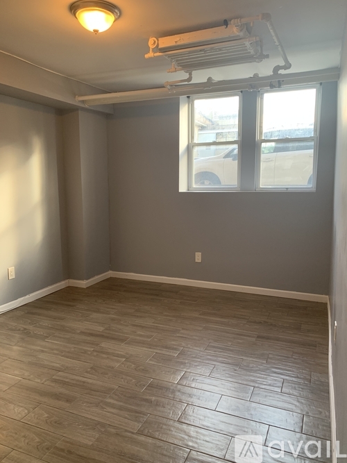 A room with a window and a ceiling fan.