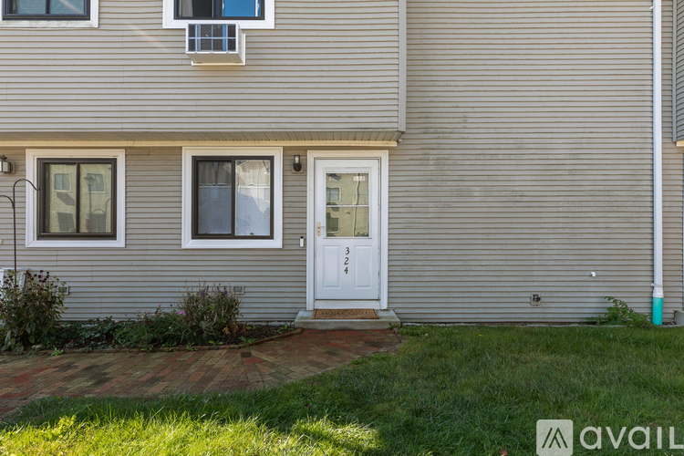 A house with a white door and windows is for sale.