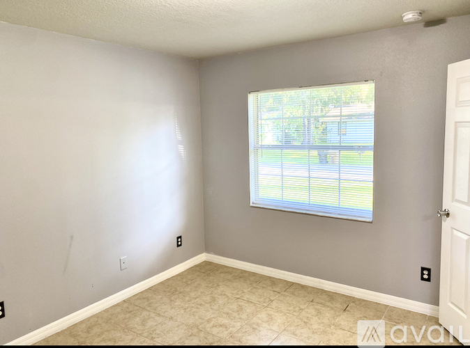 A room with a window and a door.