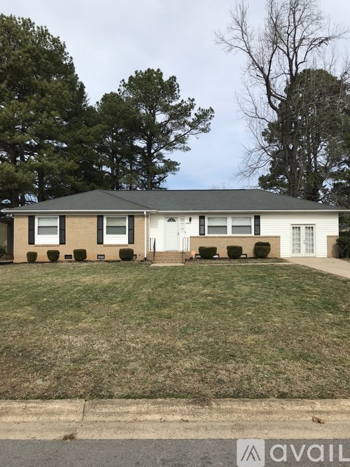A house with a brown and white exterior is for sale.