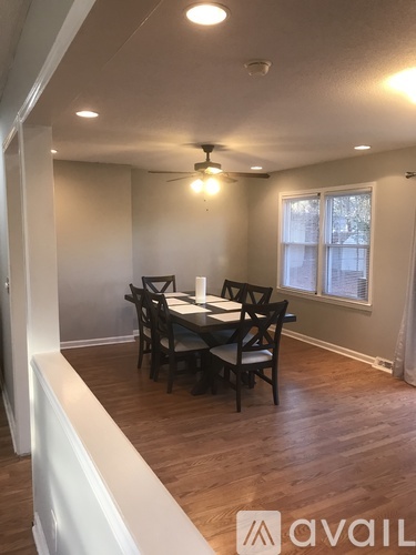 A dining room with a table and chairs.