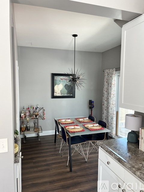 A dining room with a table set for a meal.