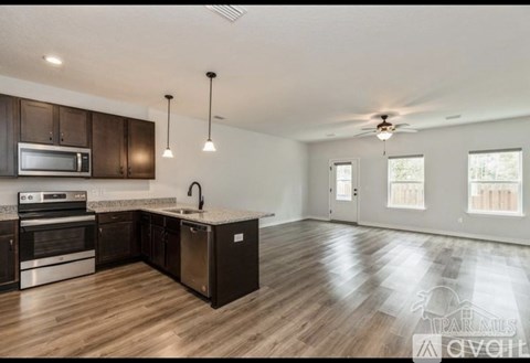 A spacious kitchen with dark wood cabinets and a center island.