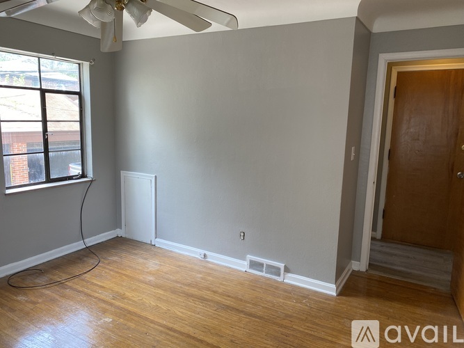 A room with a fan and a window.