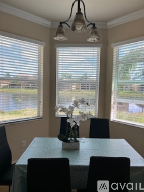 A dining room with a table and chairs.