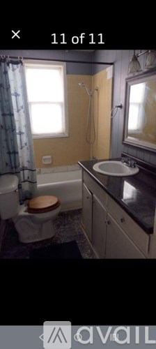 A bathroom with a toilet, sink, and shower.