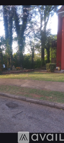 A backyard with a lawn and trees.