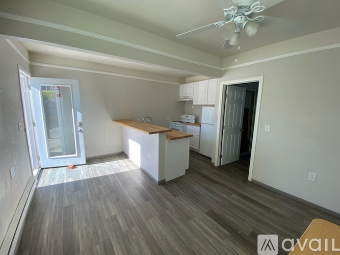 A room with a wooden floor and a ceiling fan.