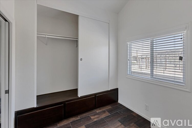 A room with a window and a wall-mounted closet.