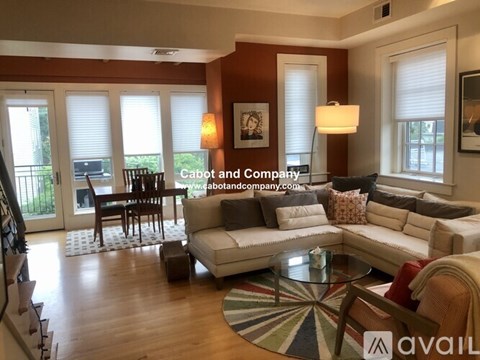 A living room with a white couch and a coffee table.