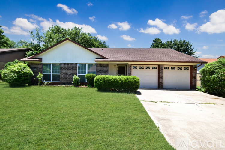 A house with a brown roof and a white garage door.
