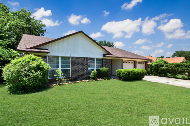 A house with a well-maintained lawn in front.