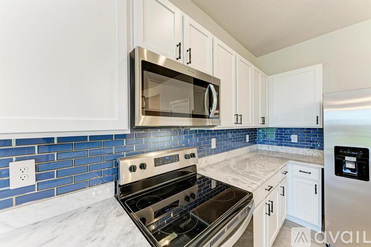 A kitchen with a stove top oven and microwave above it.