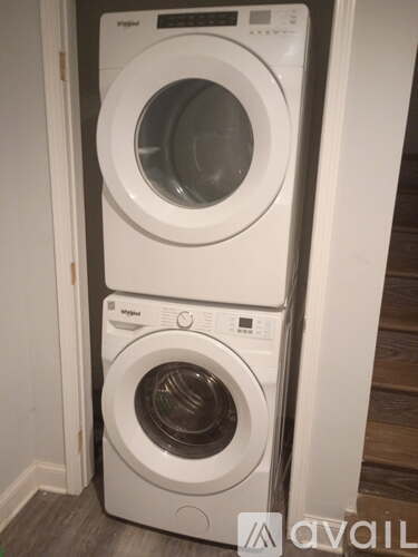 A white washing machine and dryer stacked on top of each other.