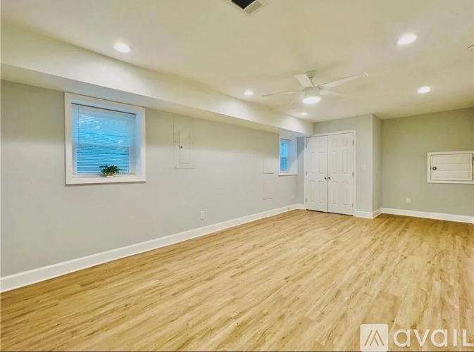 A room with wooden flooring and a ceiling fan.