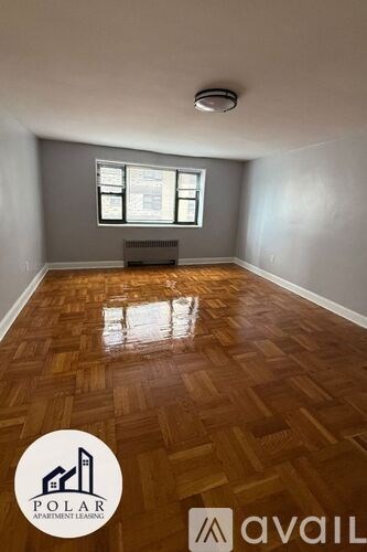 A room with wooden flooring and a window is available for rent.