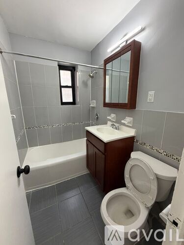 A bathroom with a toilet, sink, and bathtub.